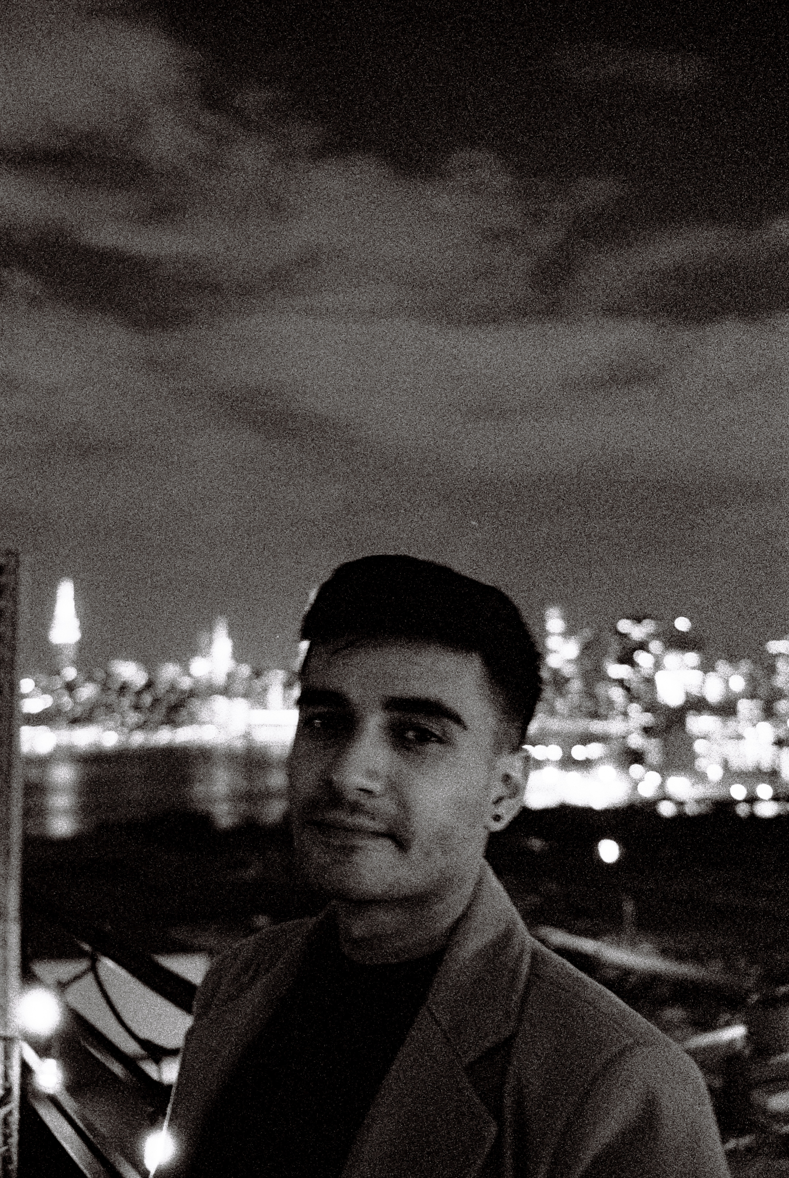 Black and white portrait of a dance instructor against a light background.